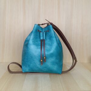 Bolso tipo bombonera color turquesa acuarela.